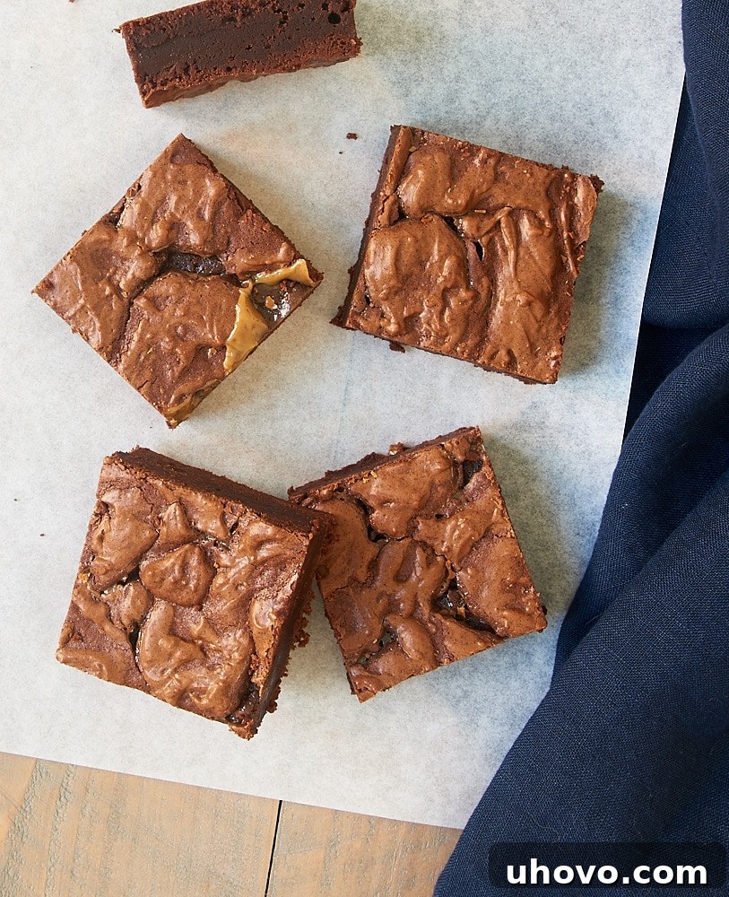 Overhead view of glistening Salted Caramel Brownies on parchment paper