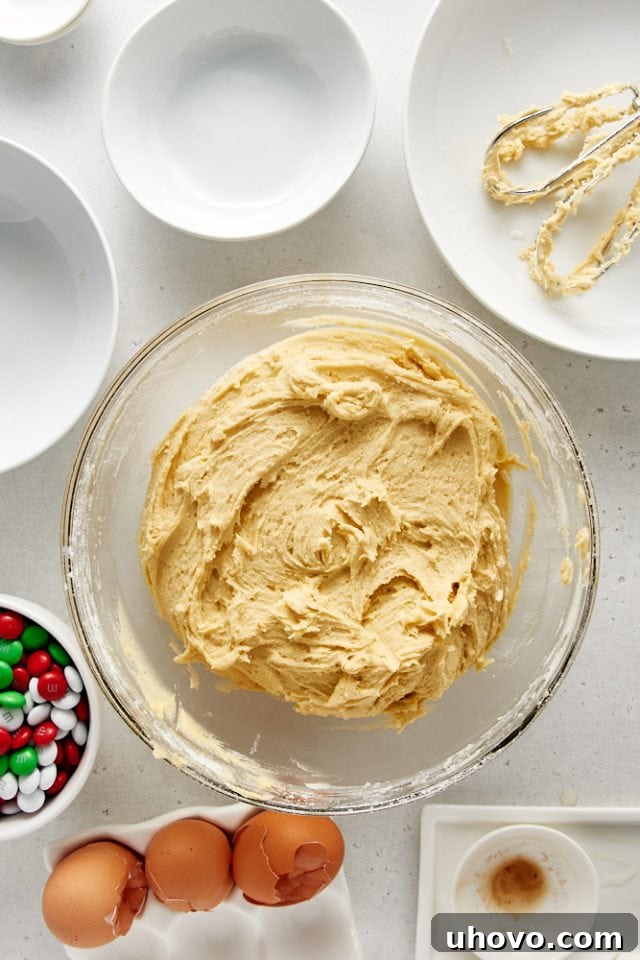 Overhead view of mixed cookie dough in a glass mixing bowl.