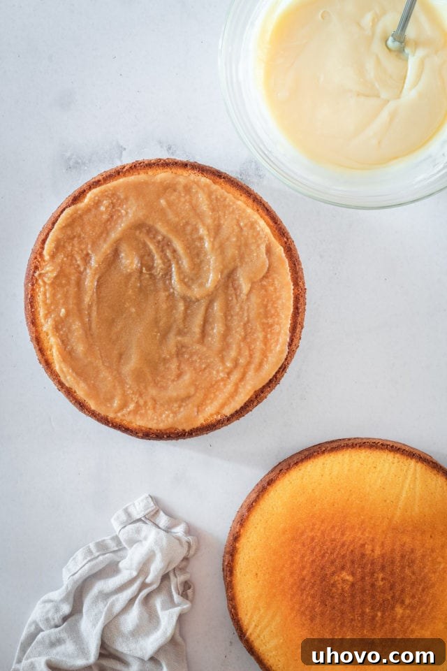 An overhead shot confirming the caramel filling has set on one layer of the Southern caramel cake, creating a solid base before the next layer of frosting is applied.