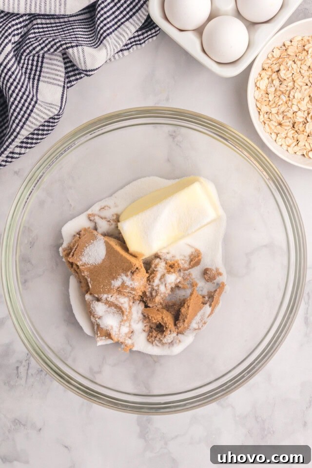 overhead view of butter, sugar, and brown sugar in a glass mixing bowl