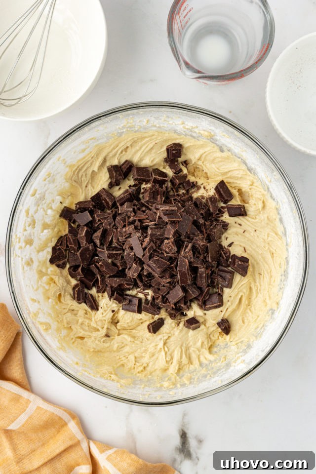 overhead view of chocolate chunks added to cupcake batter