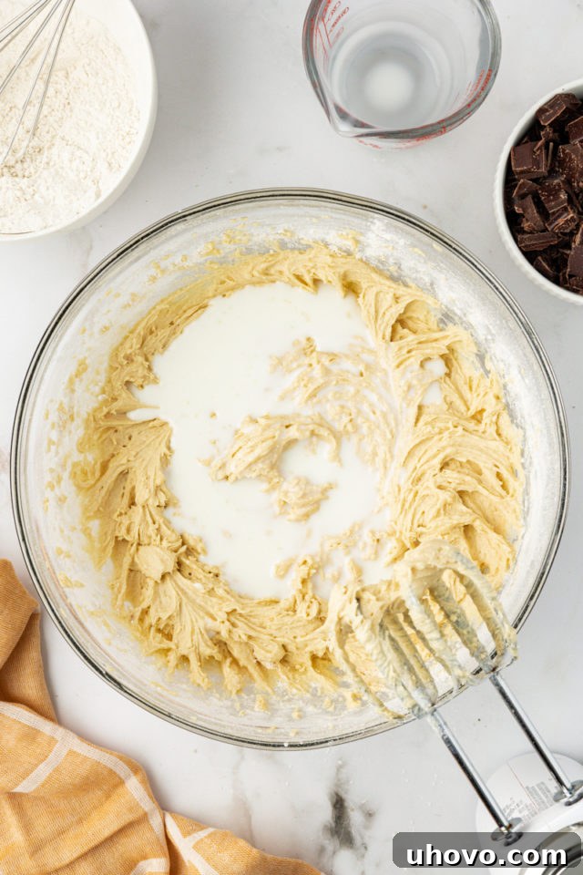 overhead view of milk added to cupcake batter