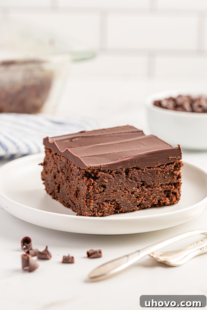 Decadent Chocolate Mascarpone Brownie on a pristine white plate, showcasing its rich texture and ganache topping.
