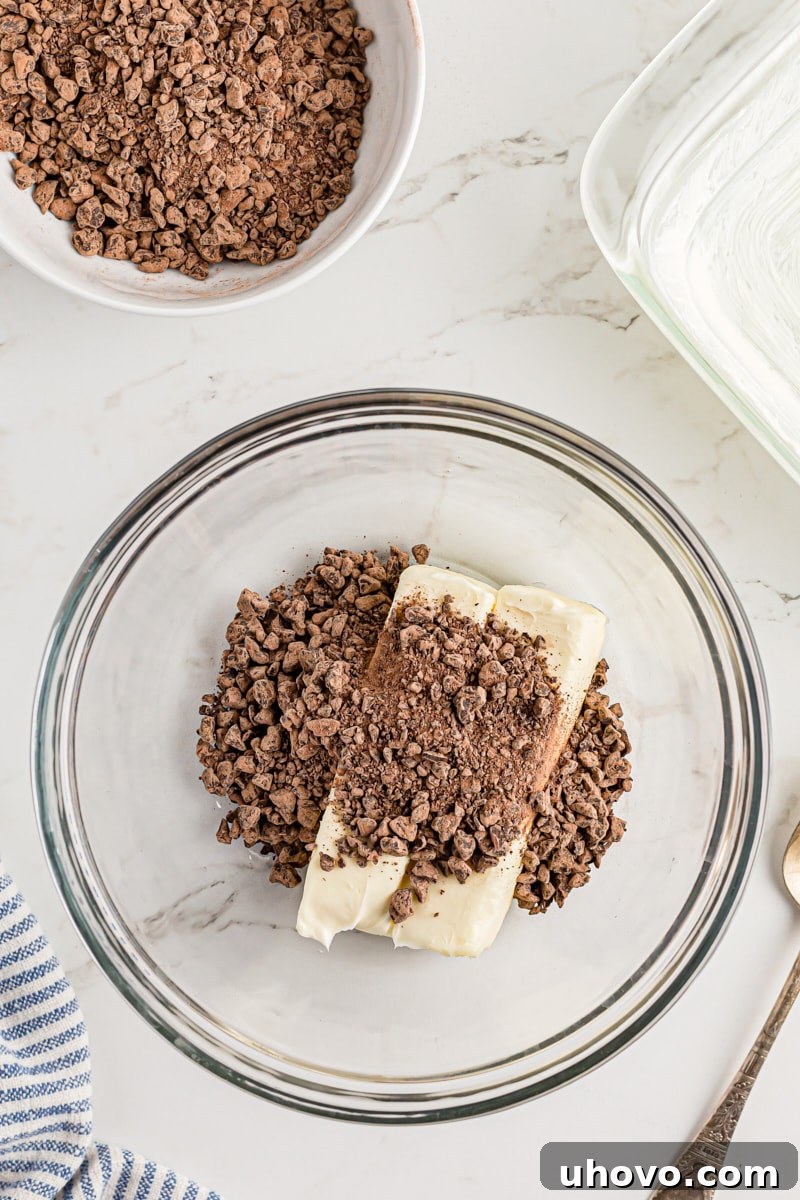 Overhead view of butter and chopped chocolate in a mixing bowl, ready for melting.