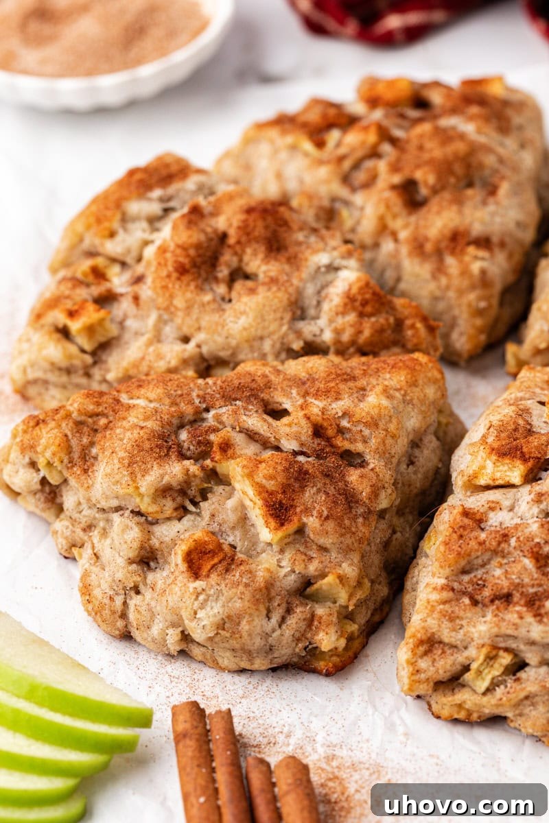 Homemade apple cinnamon scones arranged in a decorative circle on a cutting board.