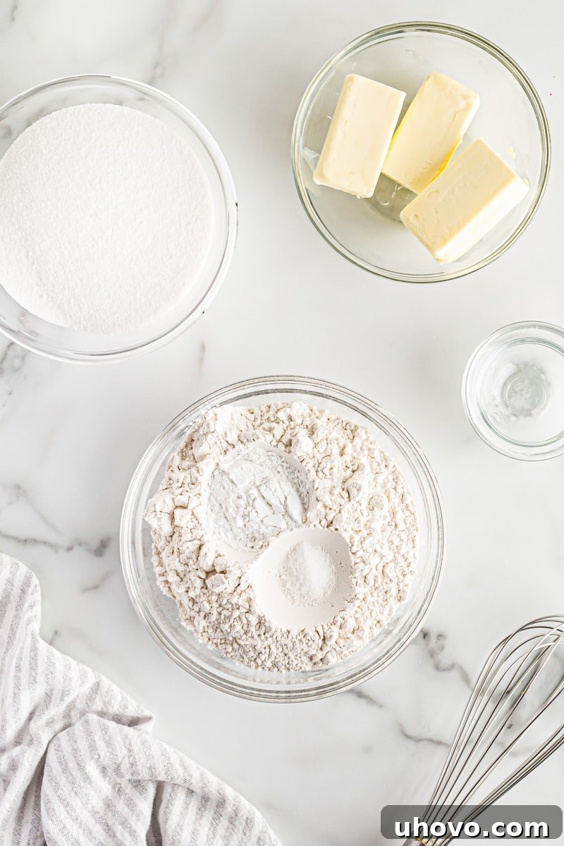 Overhead view of a bowl containing all-purpose flour, baking powder, and salt, ready for mixing.