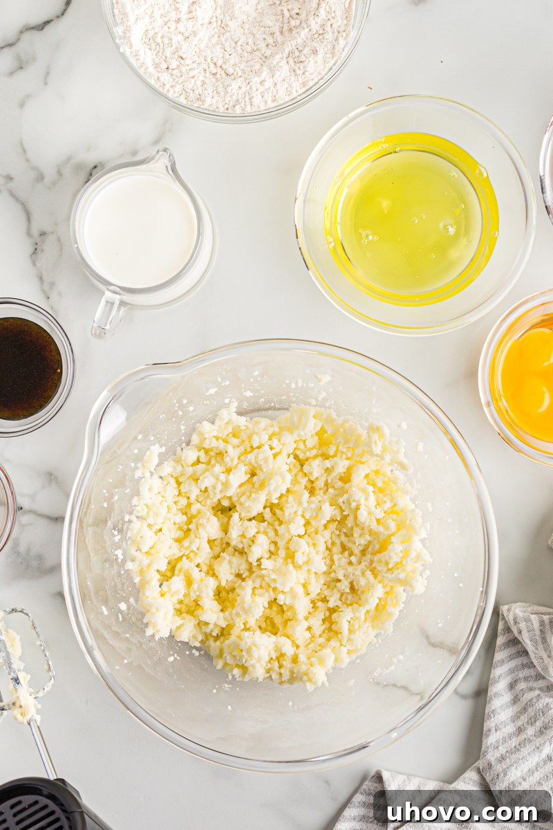 Overhead view of creamed butter and sugar, light and fluffy, in a mixing bowl.