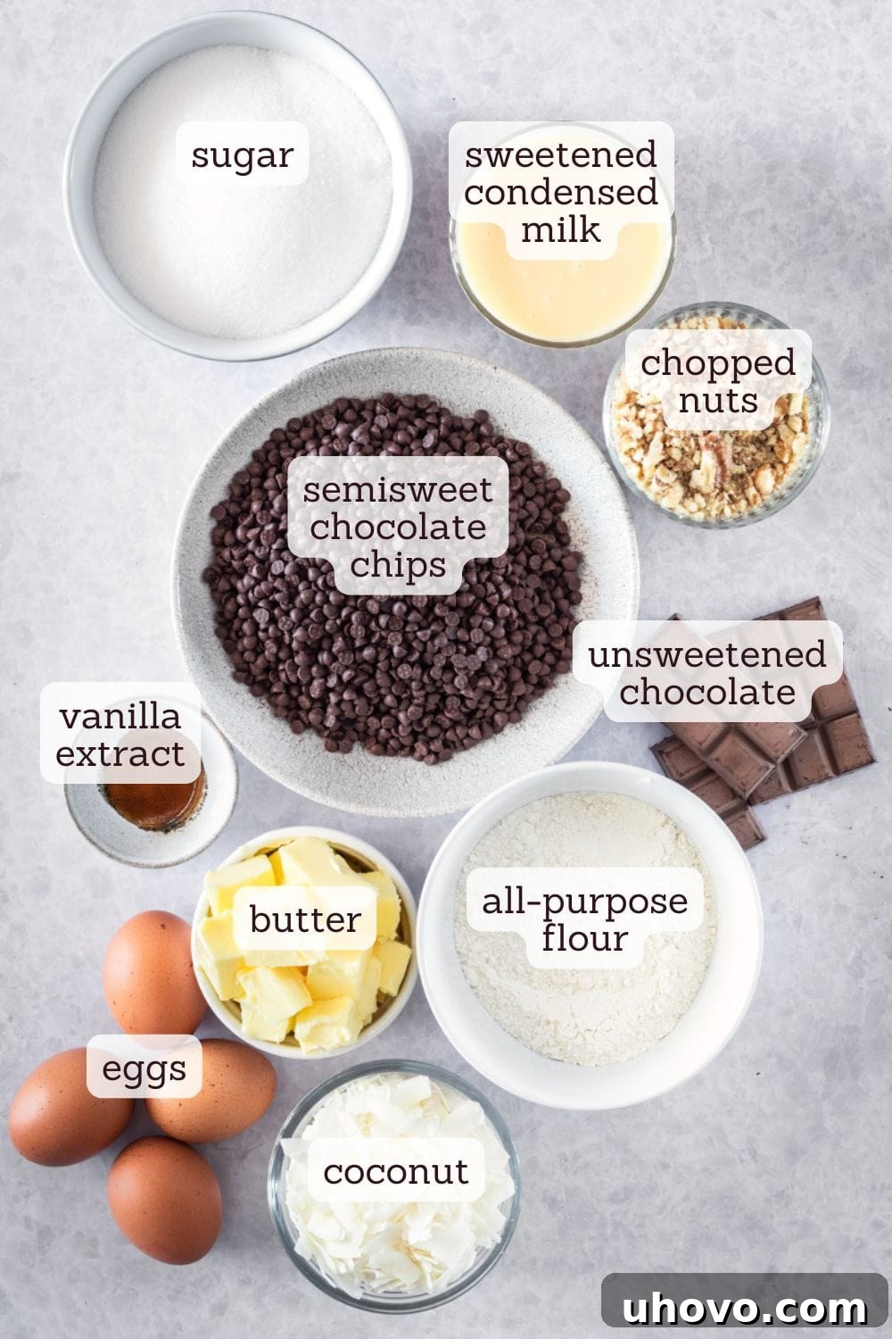 overhead view of labeled ingredients for caramel coconut pecan brownies, neatly arranged for preparation