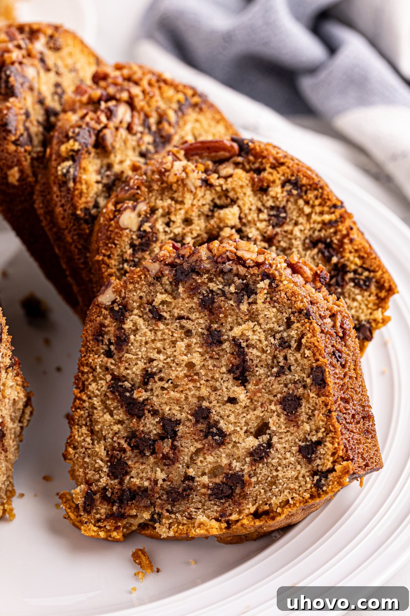 Several neat slices of chocolate chip Bundt cake artfully arranged on a white cake plate, ready to be served.