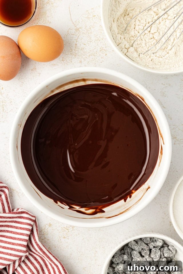 Bittersweet chocolate and unsalted butter melted together in a heatproof bowl, ready to be incorporated into the wet ingredients.