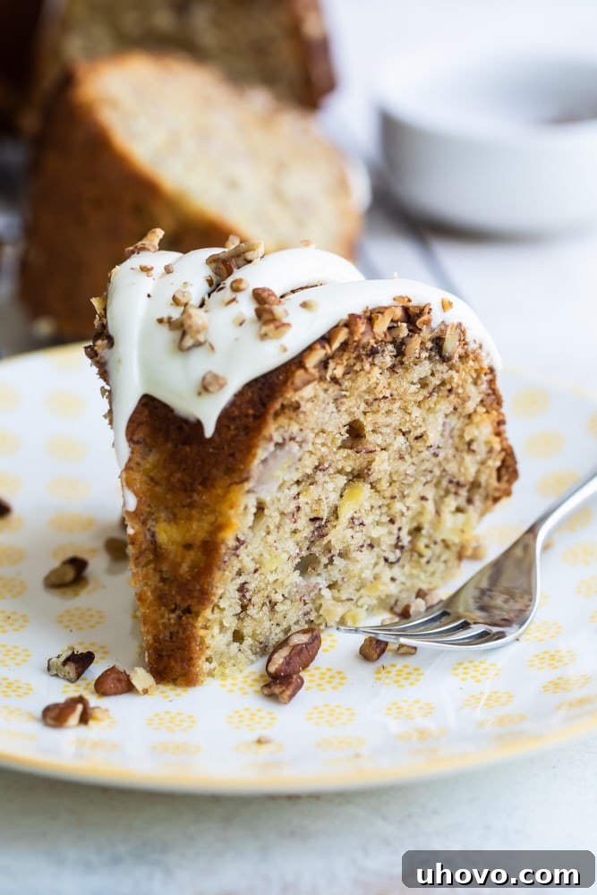 slice of Hummingbird Bundt Cake on a white and yellow plate
