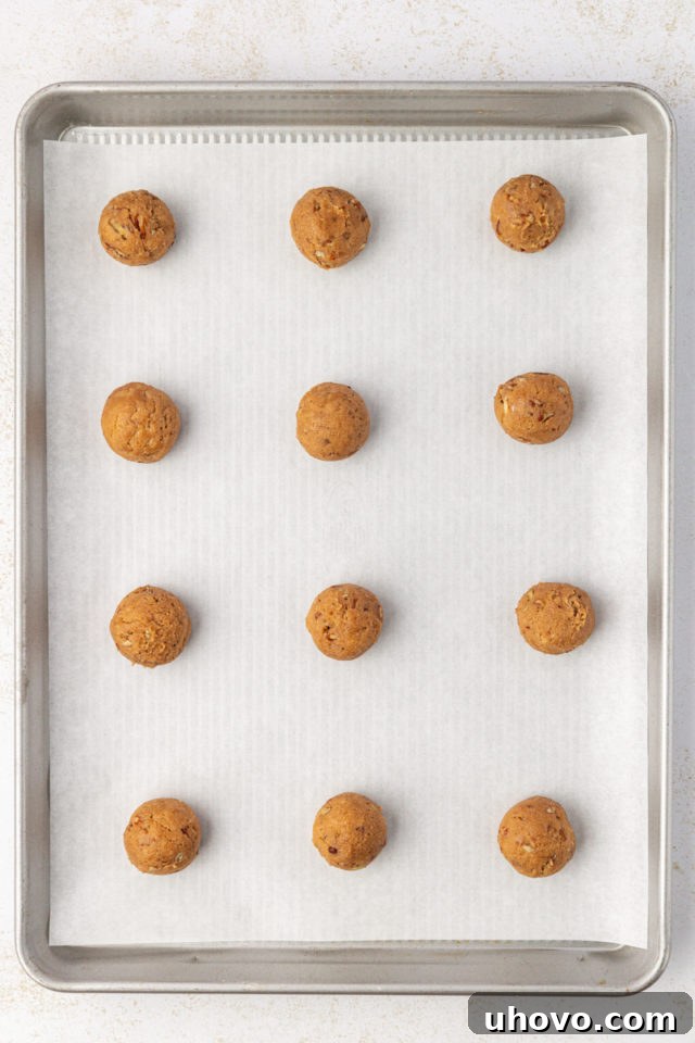 Overhead view of perfectly rolled brown sugar crinkle cookie dough balls, ready for baking.