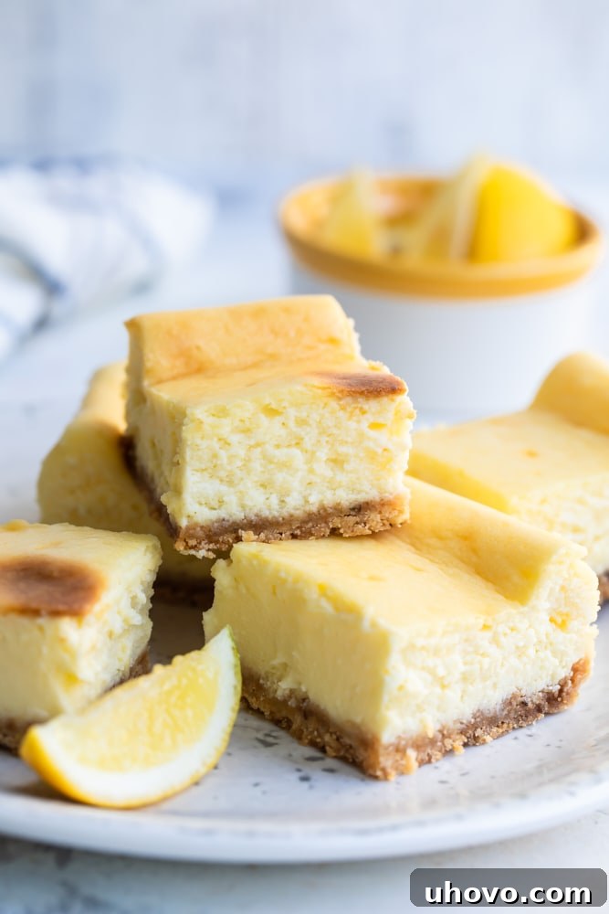 Limoncello Cheesecake Squares stacked on a white plate