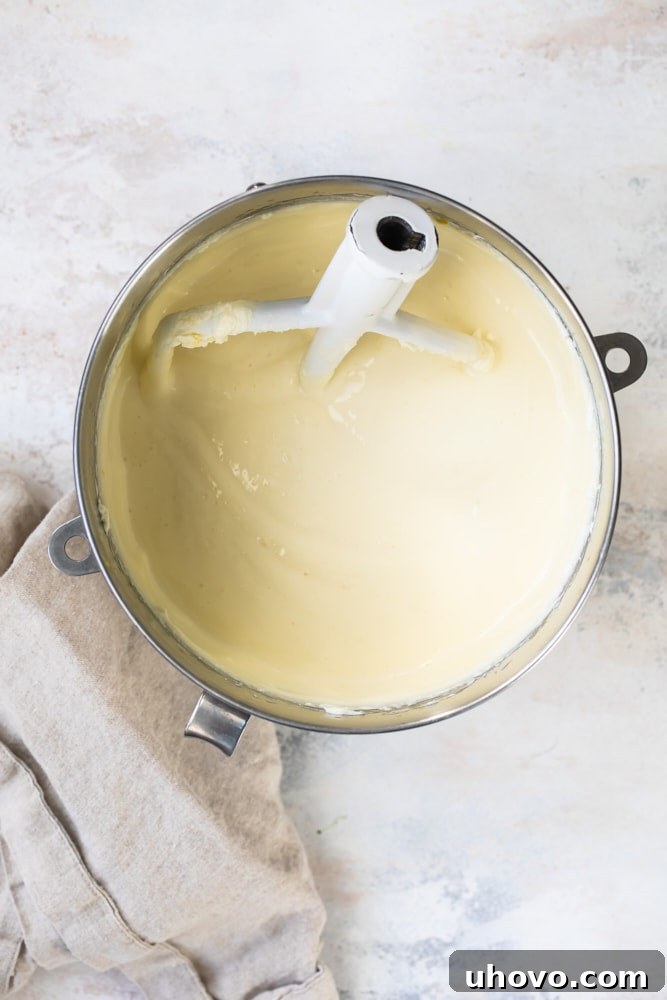 Mixing bowl filled with smooth, pale yellow Limoncello cheesecake batter