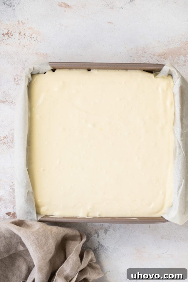 Overhead view of Limoncello Cheesecake Squares in a pan, ready for the oven