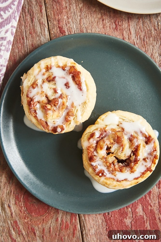 Another overhead shot of Berry Cream Cheese Pastry Swirls, highlighting the vibrant berry jam and crunchy nut filling, topped with a delicate white glaze.