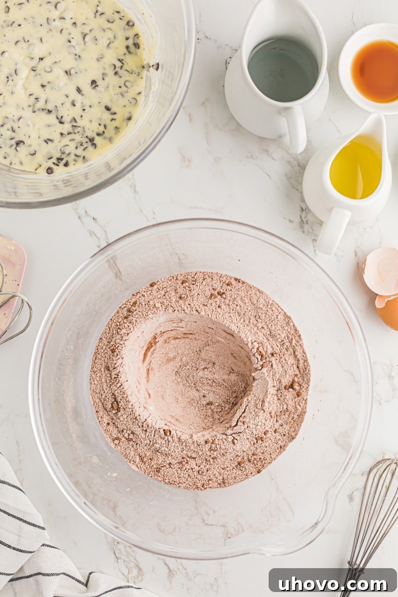 Making a well in the dry ingredients.