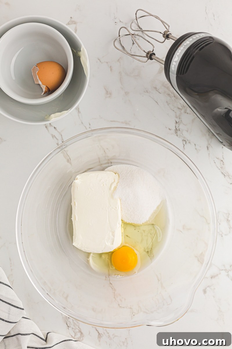 Butter, sugar, and egg in a glass mixing bowl.