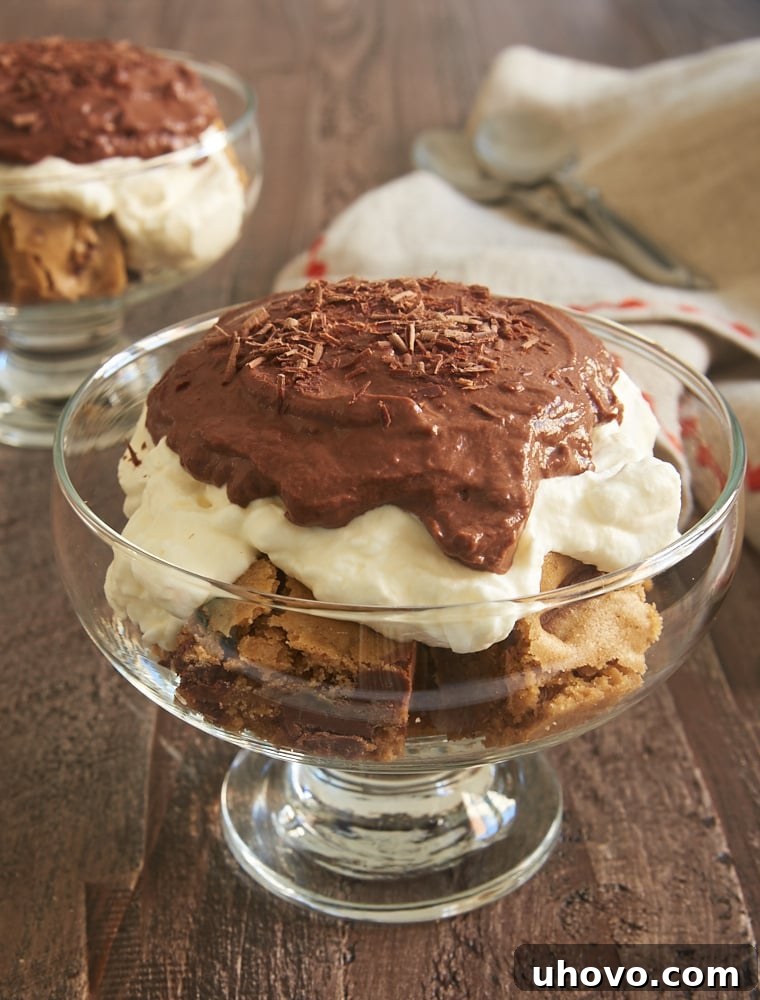 Blondie Pudding Trifles served in elegant footed glass bowls, showcasing distinct layers of blondies, pudding, and whipped cream.