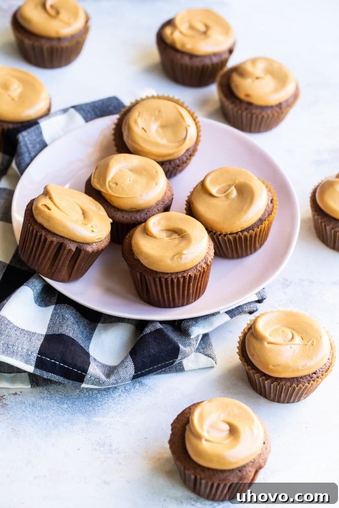 Mexican chocolate cupcakes on plate with additional cupcakes on tabletop