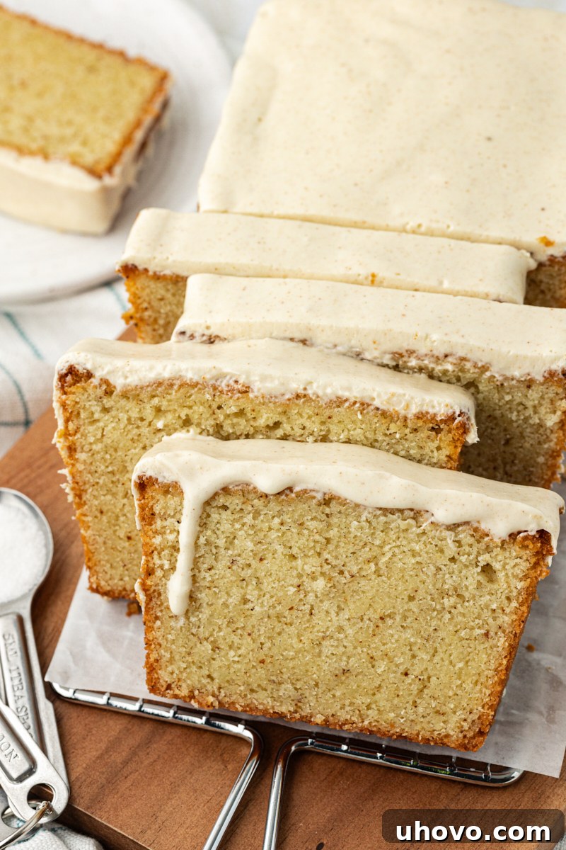 A partially sliced brown butter pound cake resting on a rustic wooden serving board, ready to be enjoyed.