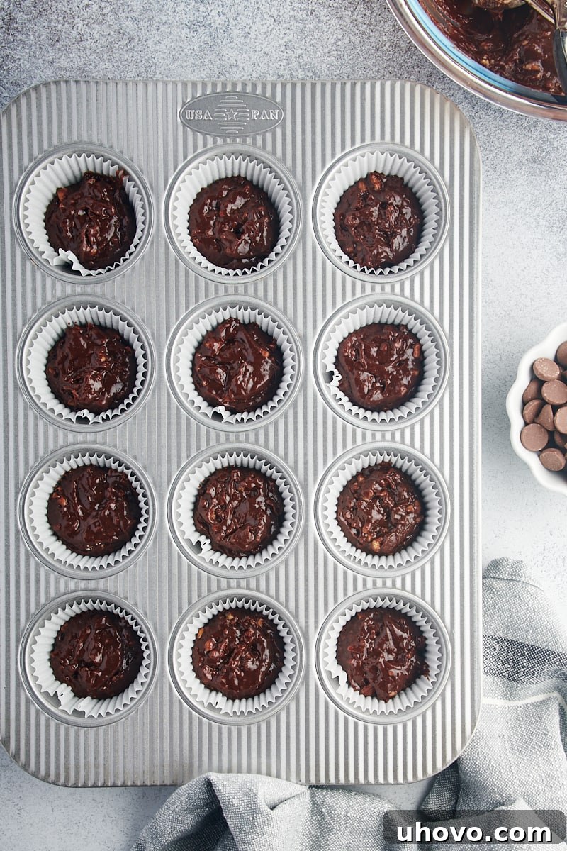 Overhead view of brownie batter in muffin tin