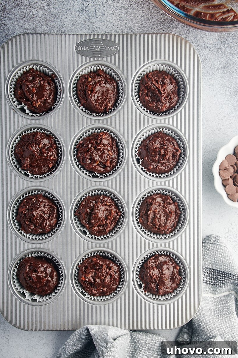 Overhead view of brownie cupcake batter in muffin tin