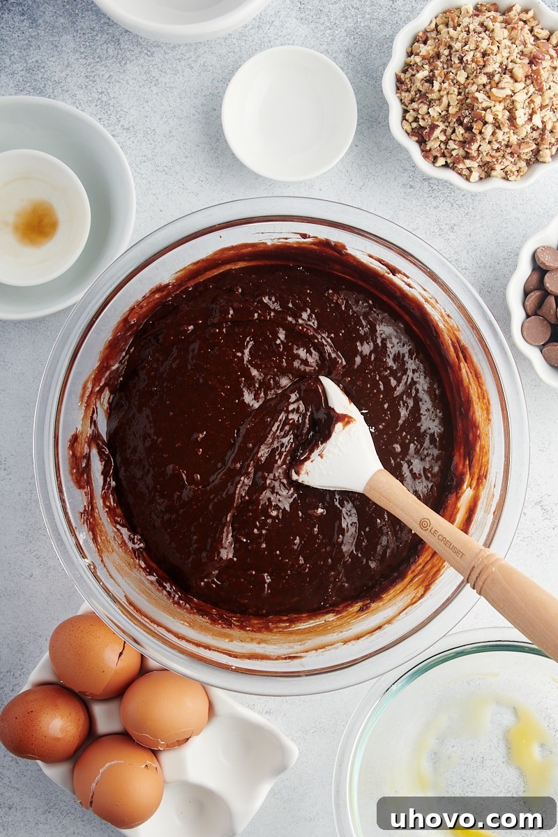 Overhead view of brownie batter in glass mixing bowl