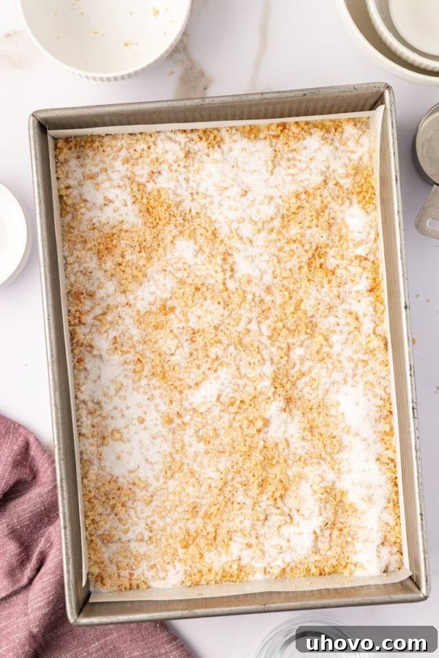 sugar sprinkled over macadamia shortbread in a baking pan