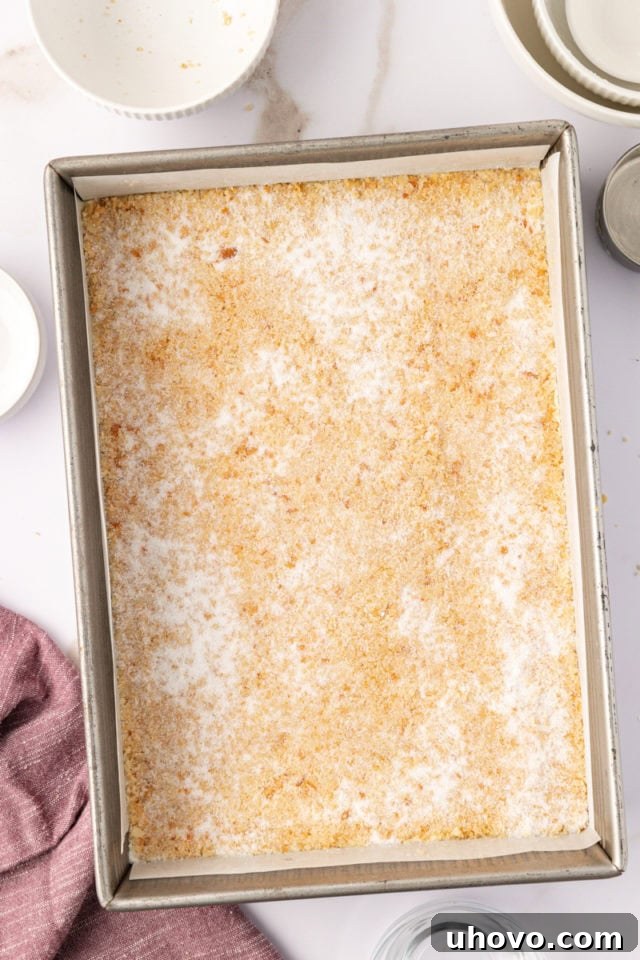 macadamia shortbread dough in a baking pan ready to go into the oven