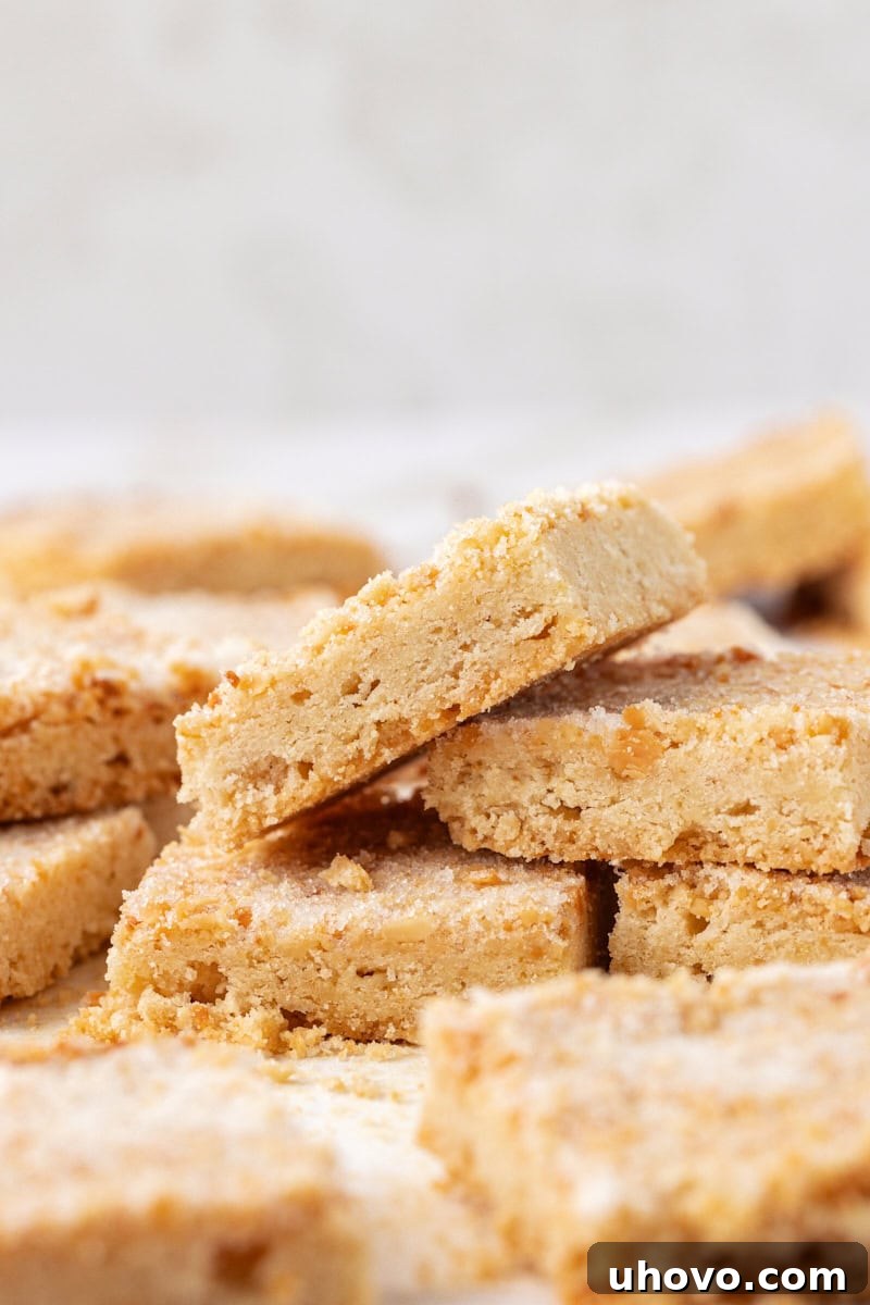 several macadamia shortbread stacked and piled on a marble countertop