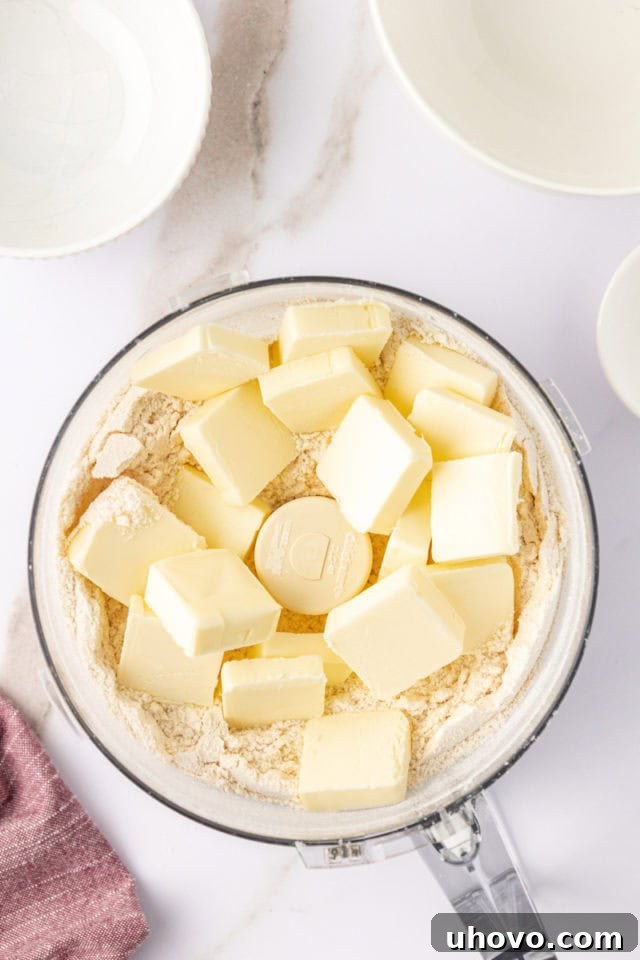overhead view of butter added to dry ingredients for macadamia shortbread