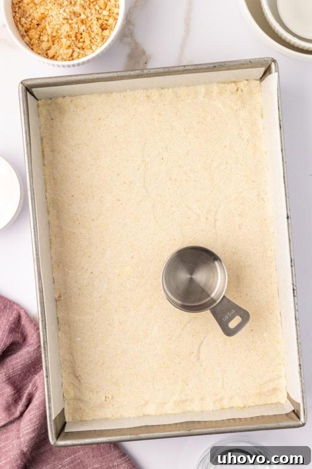 overhead view of macadamia shortbread dough pressed into a baking pan