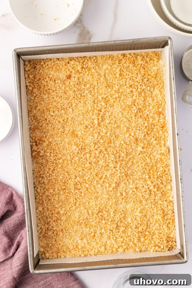 overhead view of macadamia shortbread sprinkled with finely chopped macadamias