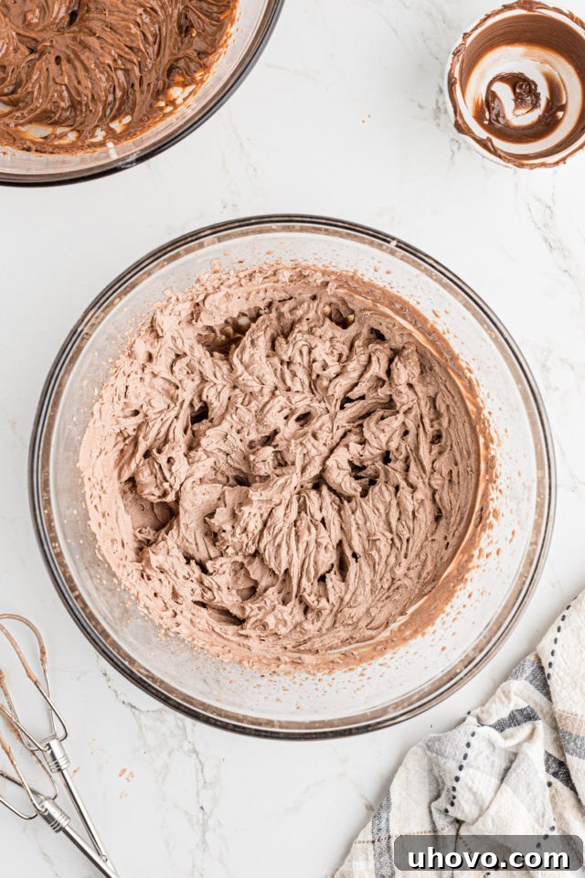 Overhead view of whipped cream in a bowl, showing stiff peaks formed after beating.