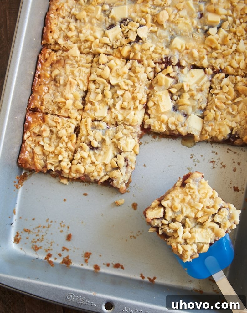 A tray of freshly baked Strawberry Magic Bars cooling, showing the golden-brown crust and vibrant toppings.
