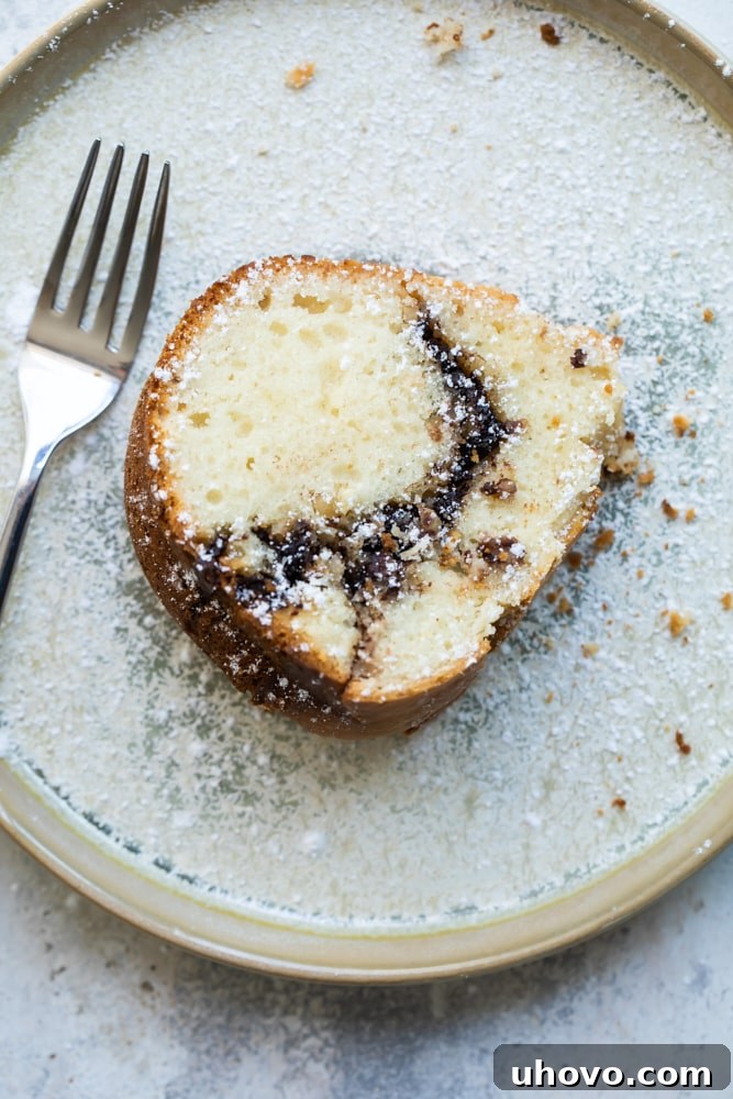 Overhead view of sour cream bundt cake with Nutella ribbon on plate with fork
