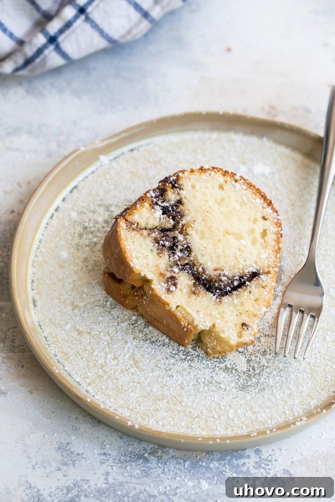 slice of Sour Cream Hazelnut Bundt Cake on a beige plate