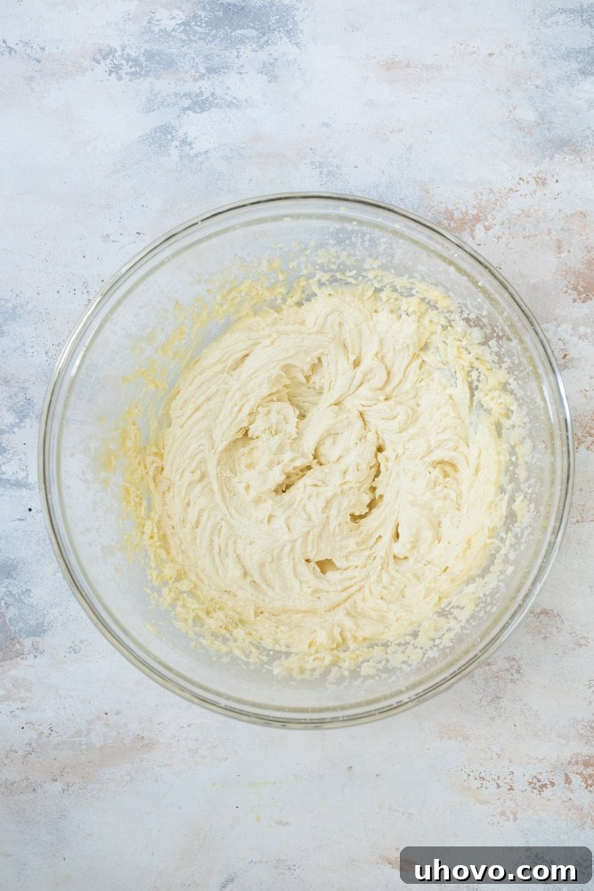 Overhead view of cake batter in glass bowl