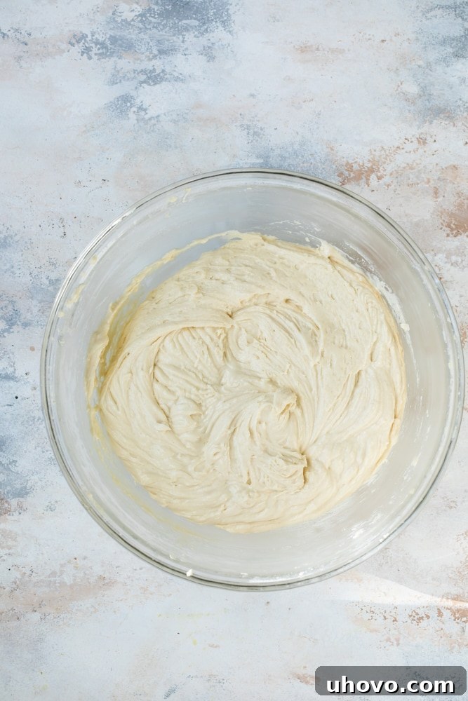 Overhead view of bundt cake batter in glass mixing bowl