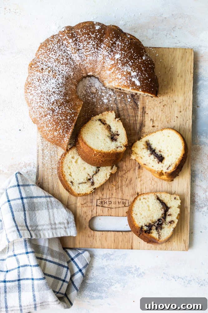 Overhead view of bundt cake on cutting board with four slices