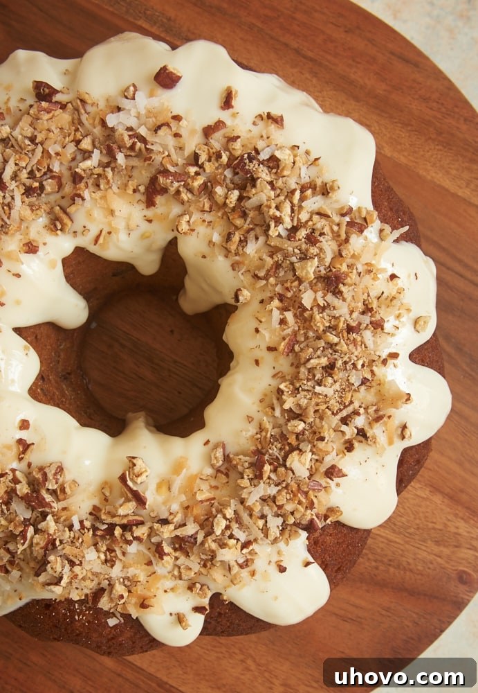 The perfect slice of Italian Cream Bundt Cake, featuring a moist crumb packed with coconut and pecans, elegantly topped with a delicate cream cheese glaze. This simple yet sophisticated dessert is a must-try for any occasion.