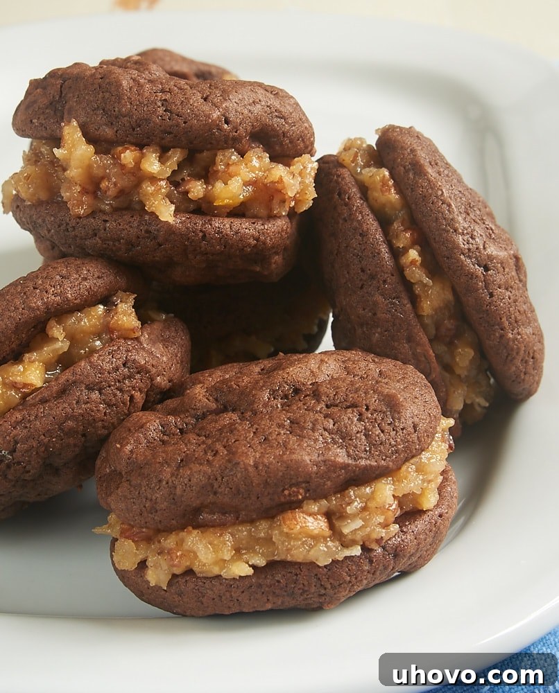 Rich Chocolate Coconut Pecan Sandwich Cookies on a pristine white plate, showcasing their generous filling and perfect texture