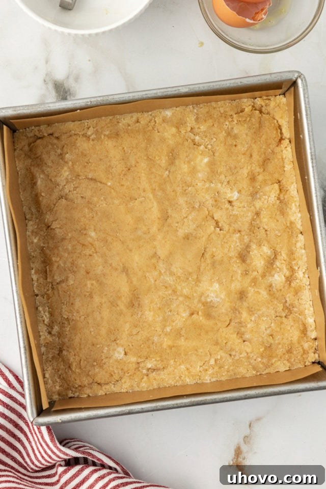 Overhead view of baked shortbread crust for raspberry crumble bars