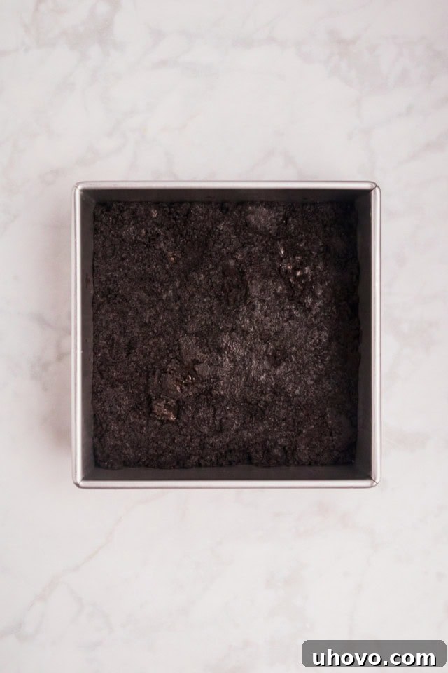 overhead view of Oreo crust pressed into the bottom of a square baking pan