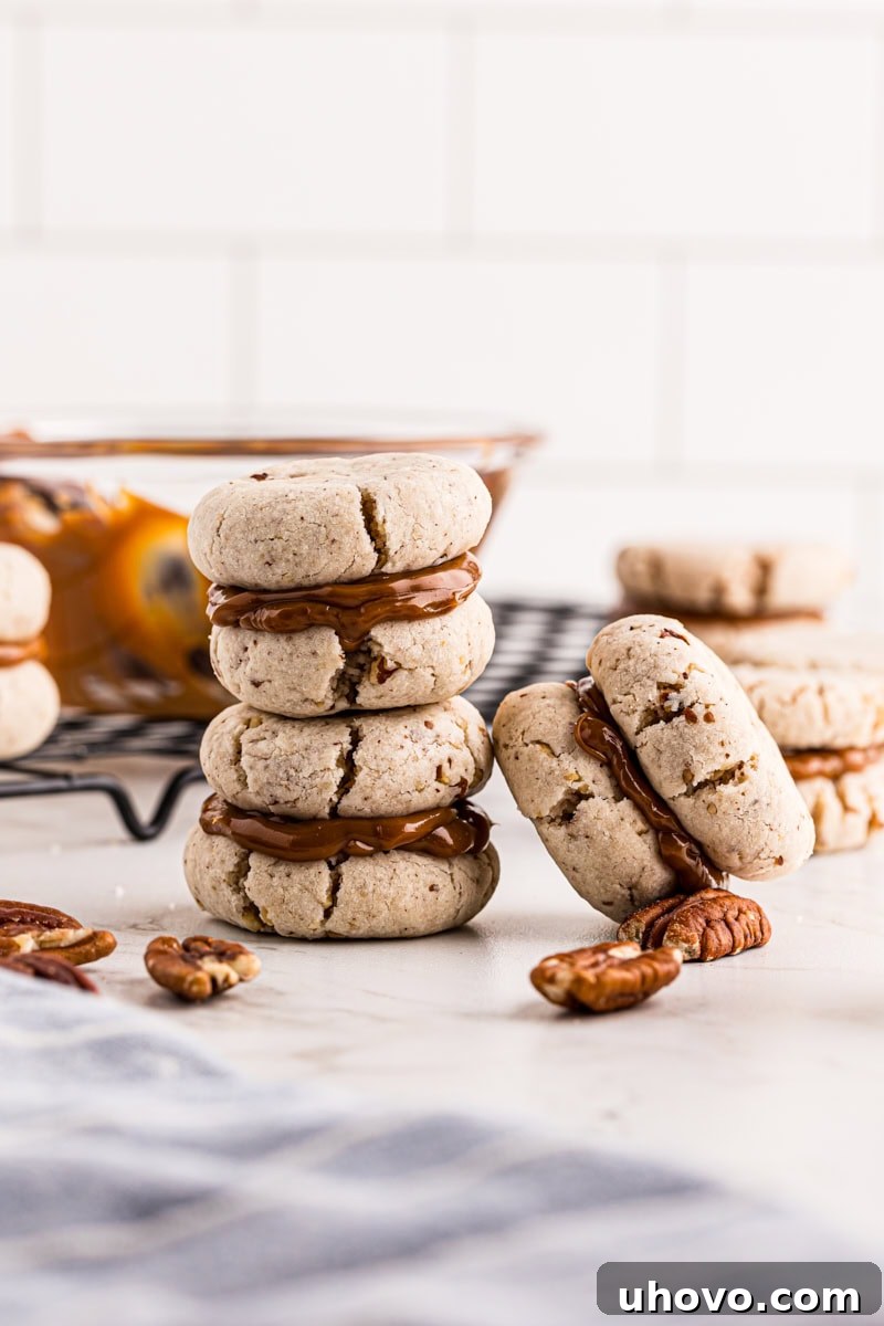 Stacked cream cheese shortbread sandwiches with dulce de leche filling, promising a melt-in-your-mouth experience.