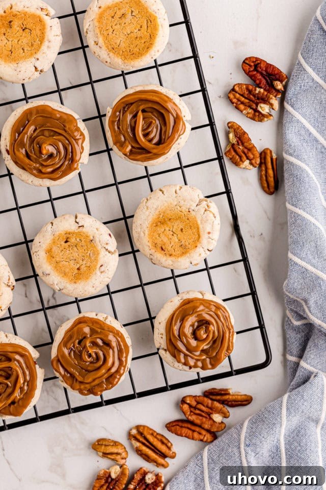 A baked cream cheese shortbread cookie with a generous dollop of dulce de leche on top, ready to be sandwiched.