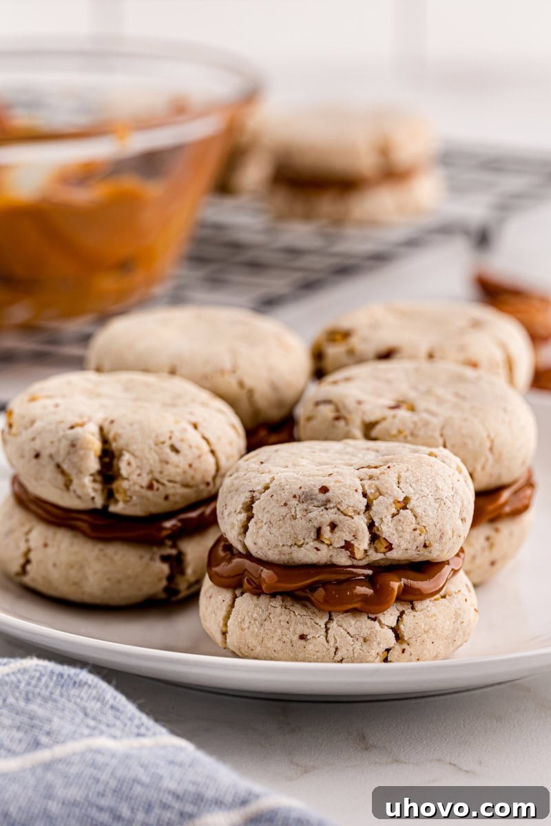 A beautifully arranged plate of finished dulce de leche cream cheese shortbread sandwich cookies, ready to be served.