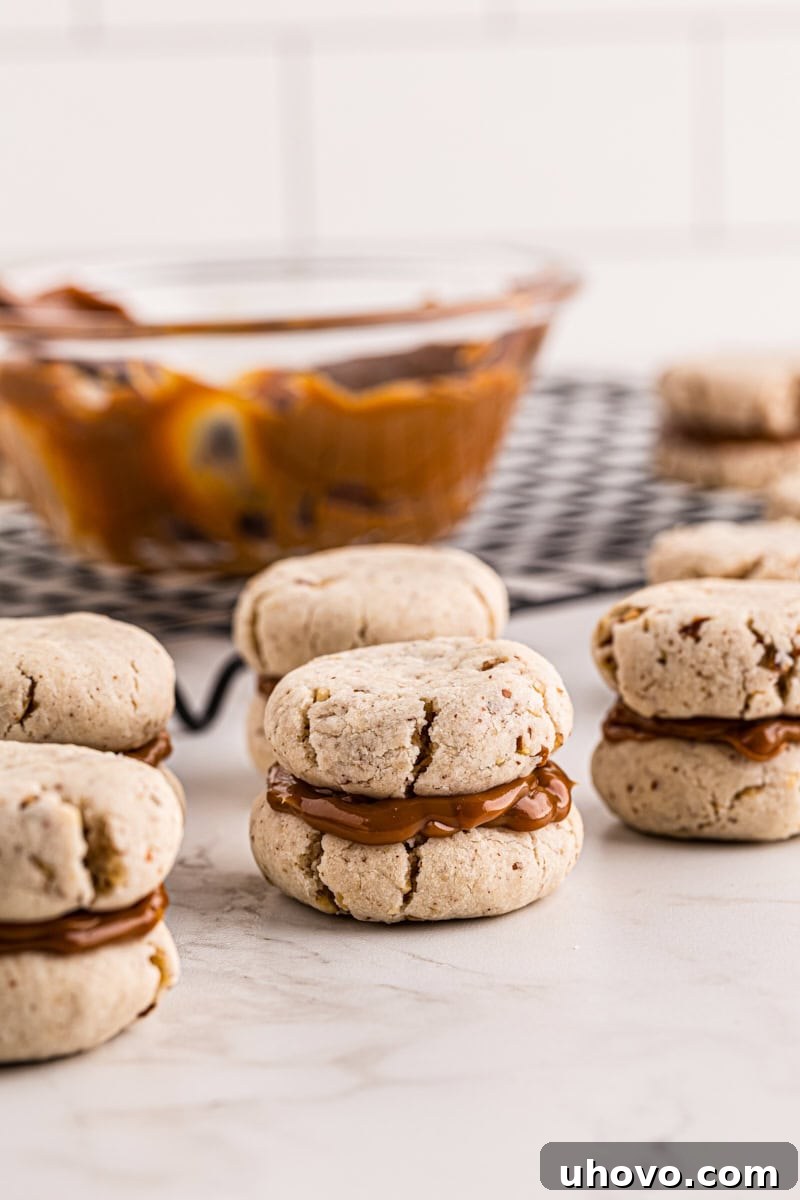 Dulce de leche cream cheese shortbread sandwiches neatly arranged on a kitchen countertop, showcasing their homemade appeal.
