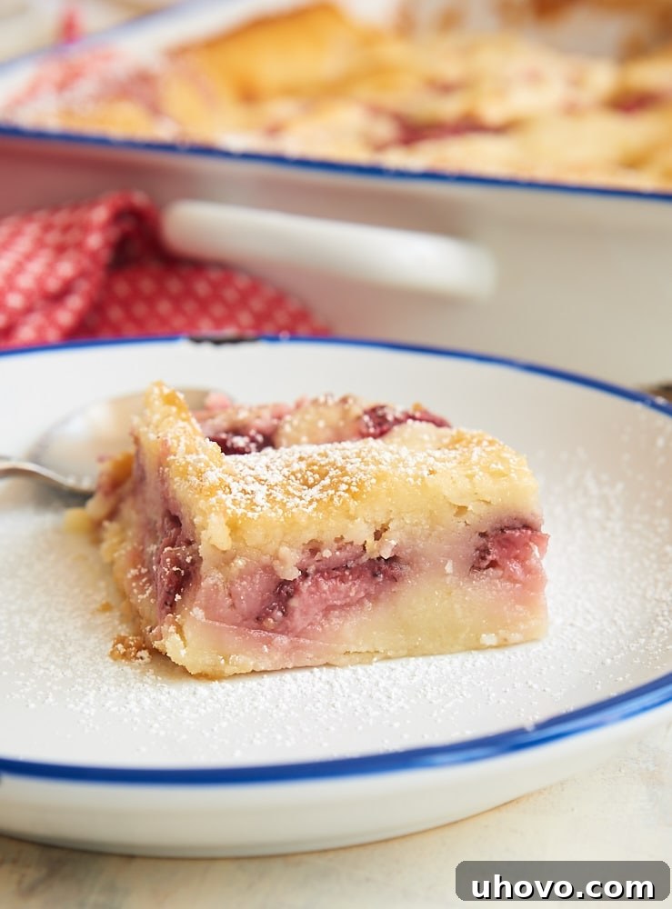 Delightful Strawberry Cheesecake Cobbler with fresh strawberries and creamy cheesecake swirls.